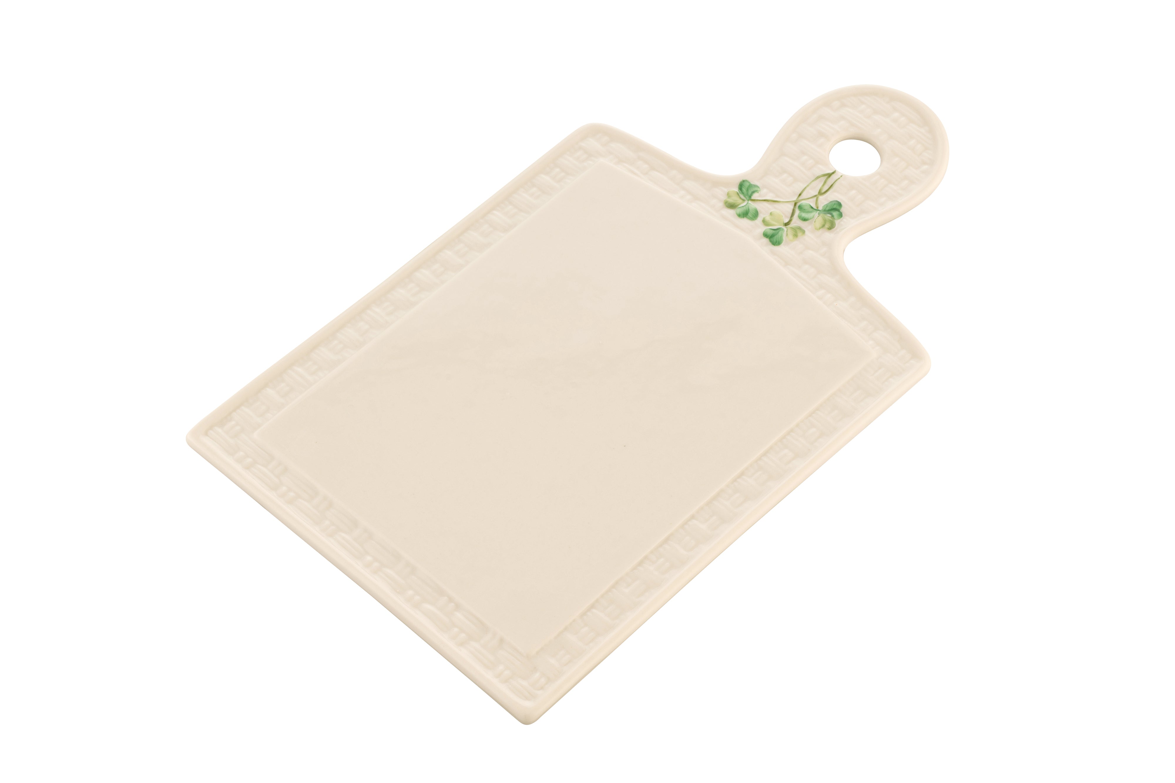 Beige ceramic cutting board with a handle featuring green leaves on a white background