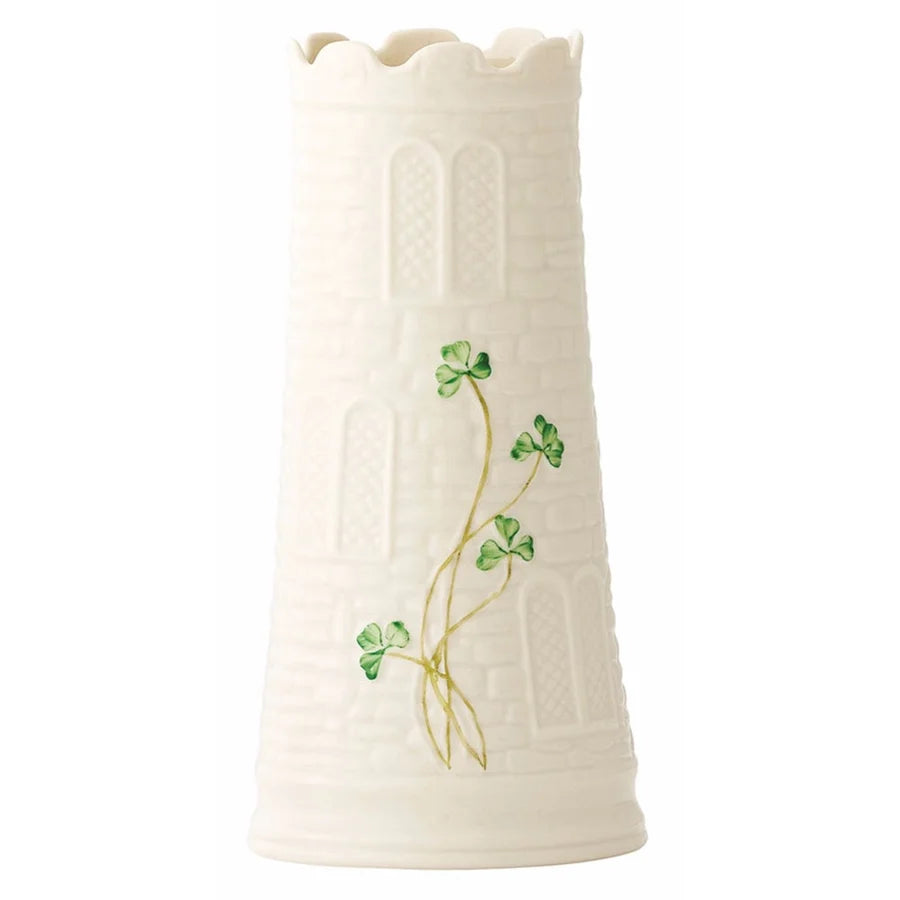 White ceramic vase with green clover designs on a white background