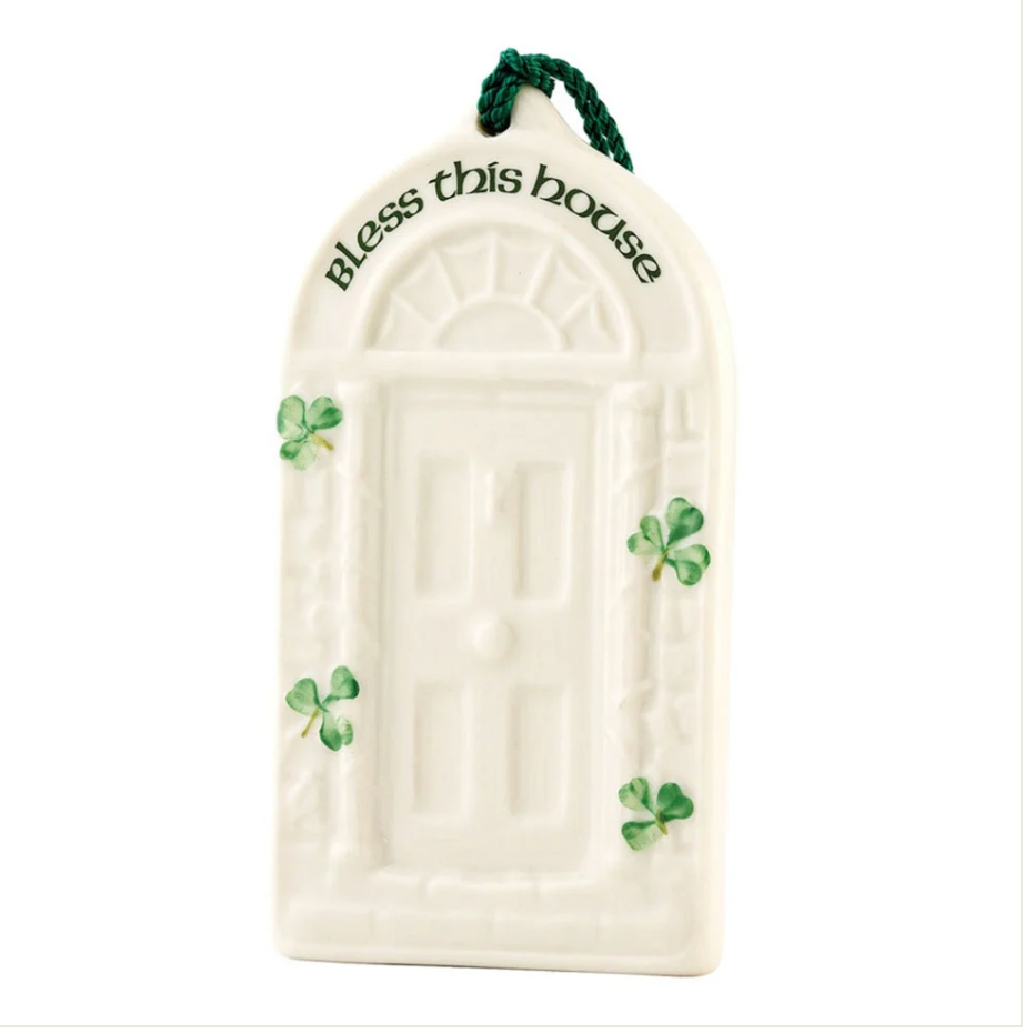 Decorative door-shaped ornament with 'Bless this house' text and shamrock designs on a white background.