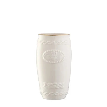 White ceramic vase with decorative patterns on a white background