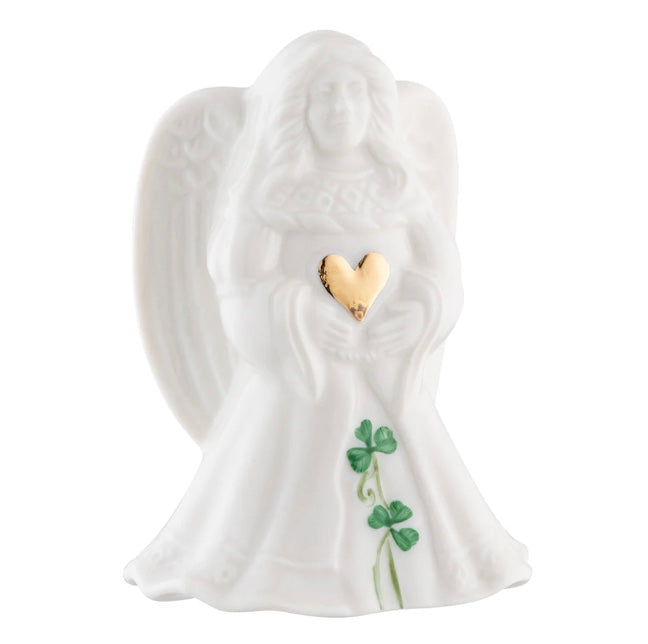 White angel figurine with a gold heart and green leaves on a white background