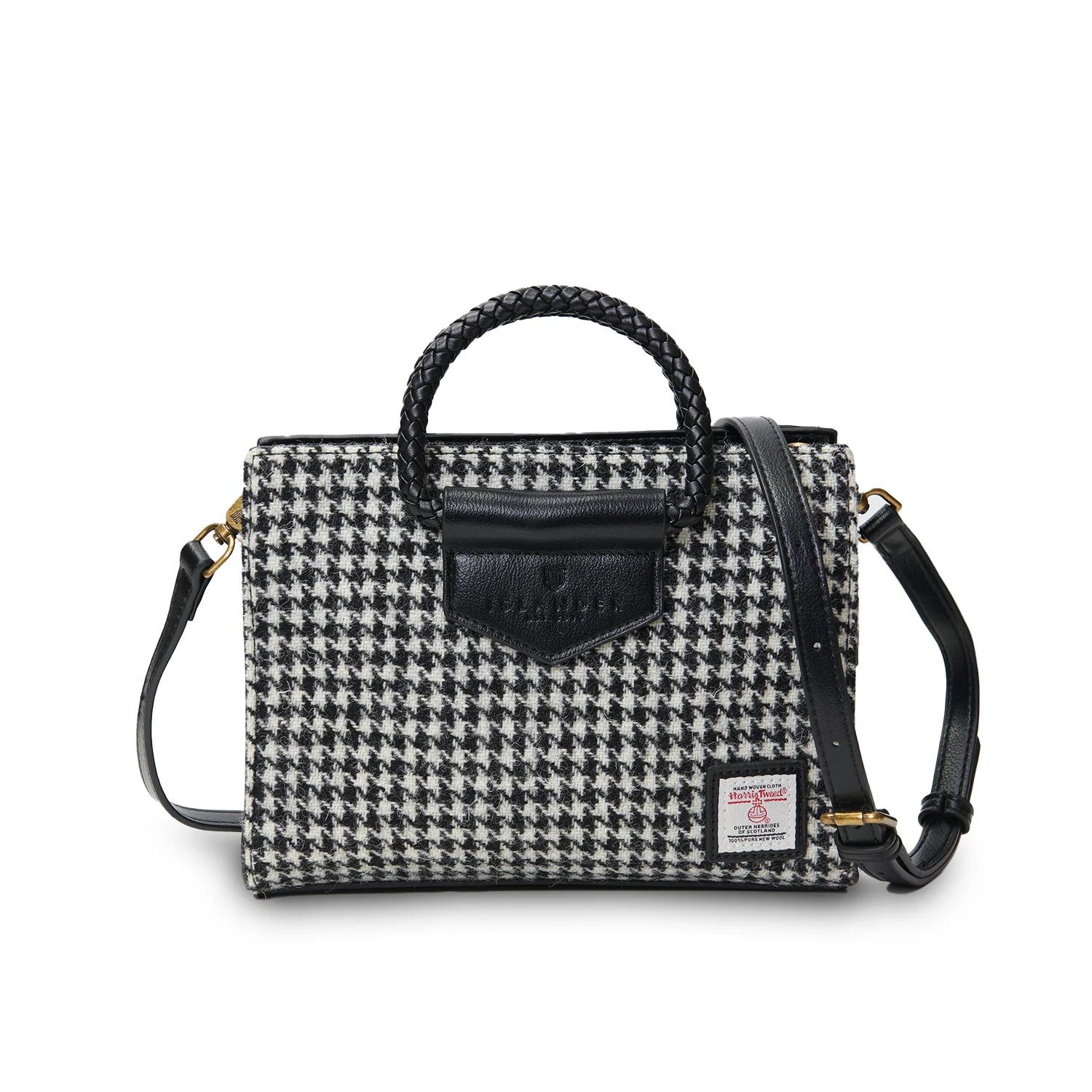 Houndstooth pattern handbag with black leather accents on a white background