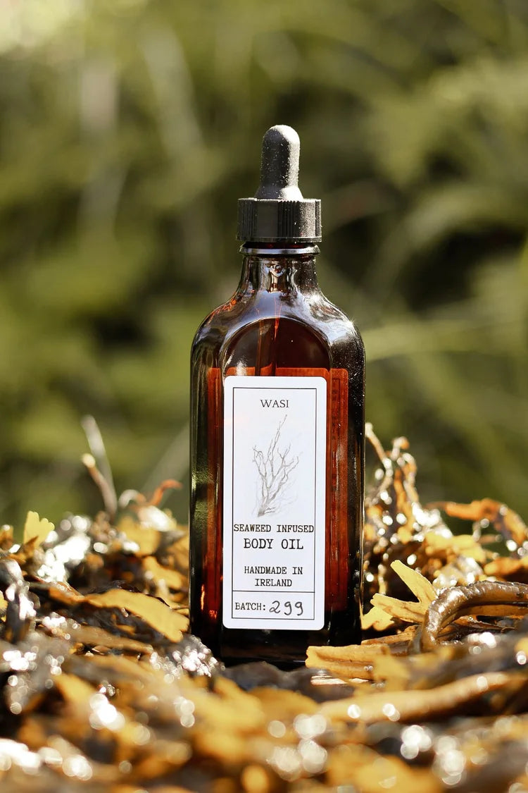 Bottle of body oil with a dropper on a natural background