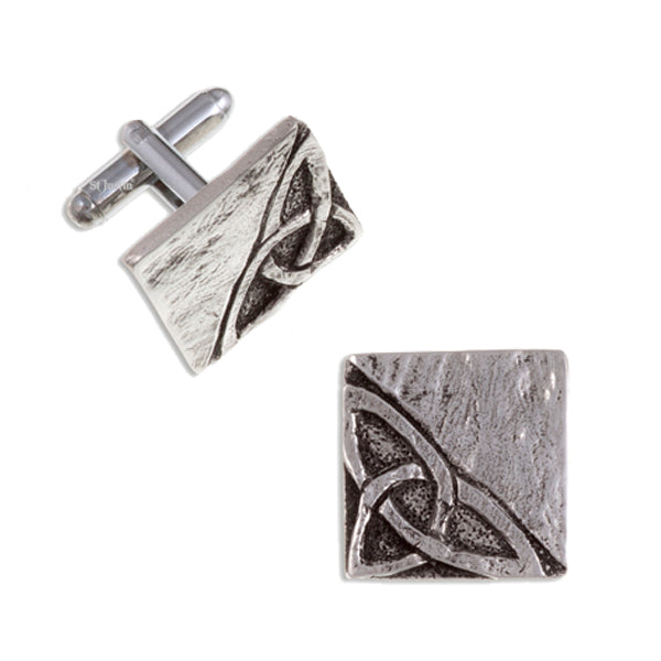 Pair of silver cufflinks with intricate design on a white background