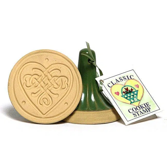Heart-shaped cookie stamp with a green handle and a tag labeled 'Classic Cookie Stamp' on a white background.