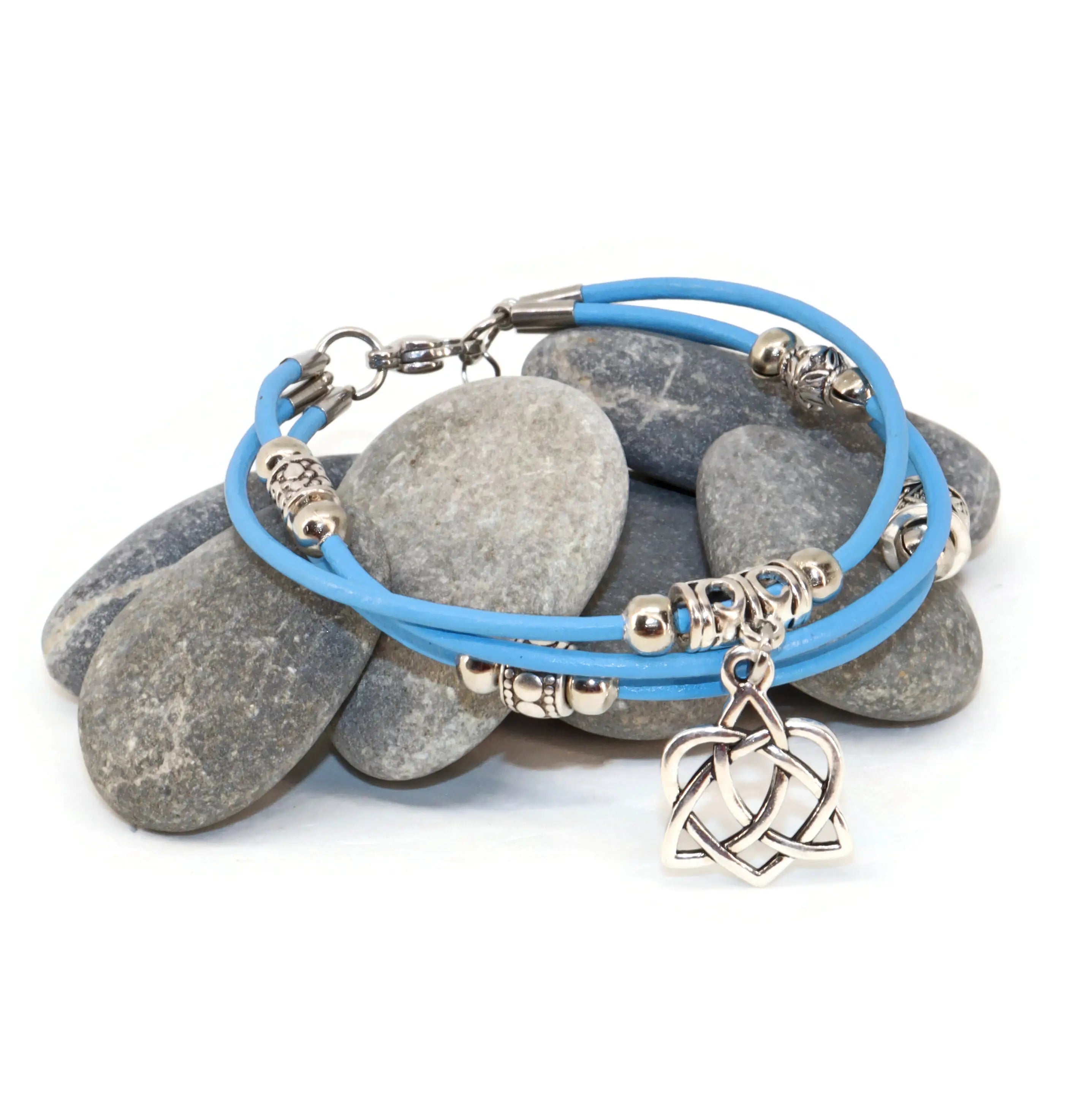 Blue bracelet with silver charms on stones