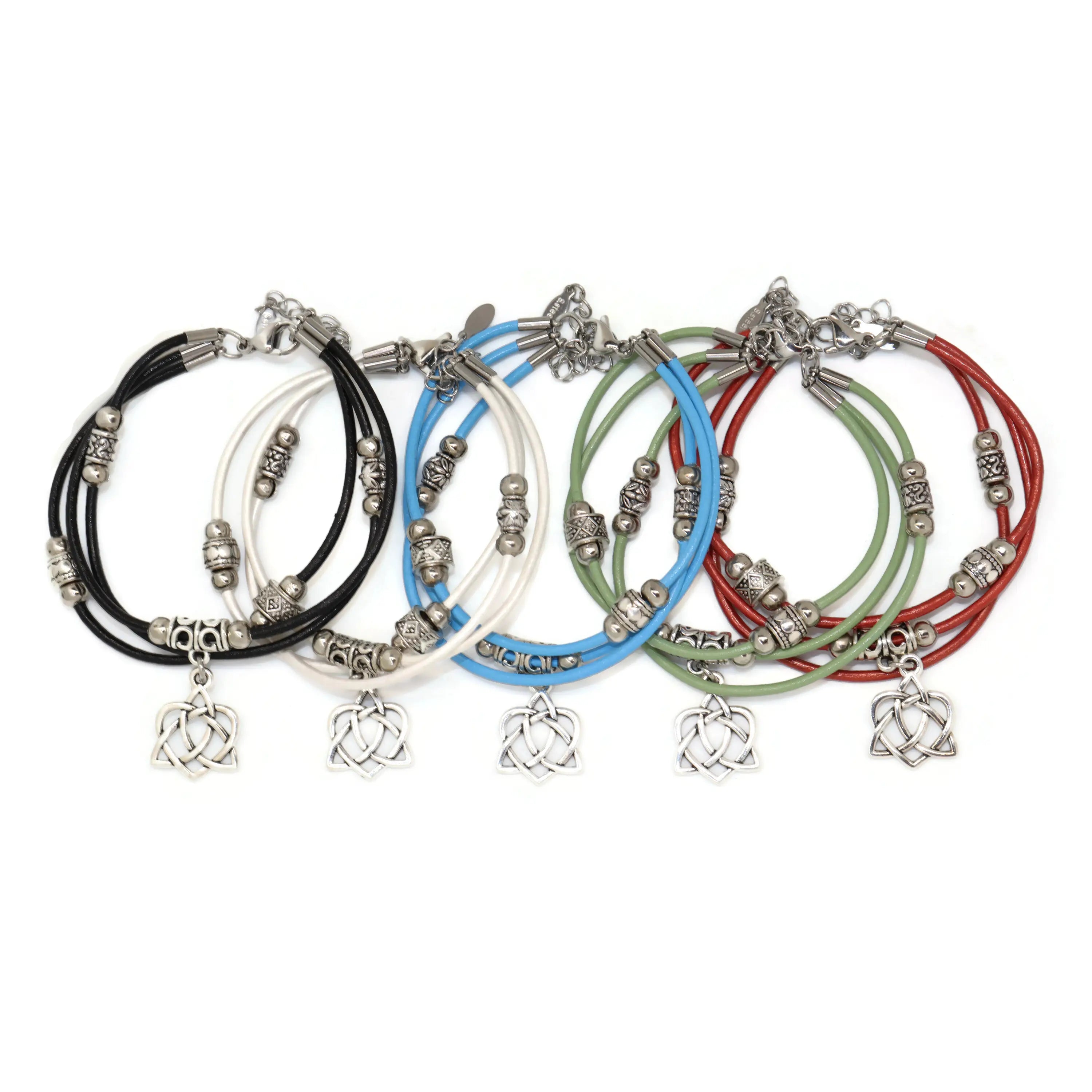 Set of five colorful bracelets with Celtic knot charms on a white background