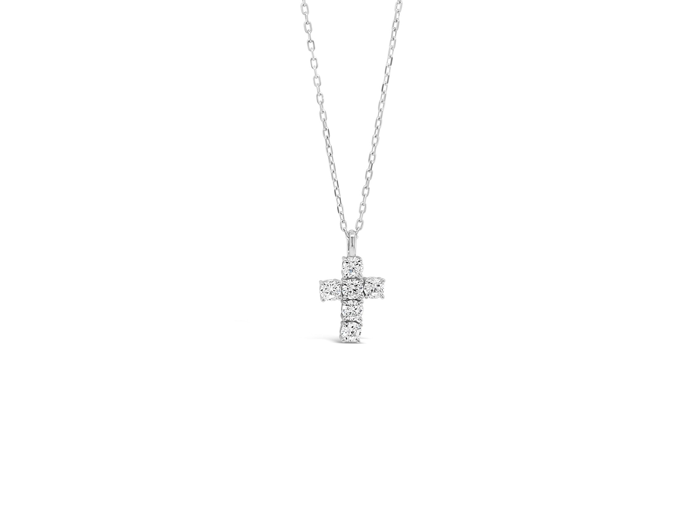 Silver cross necklace with clear stones on a white background