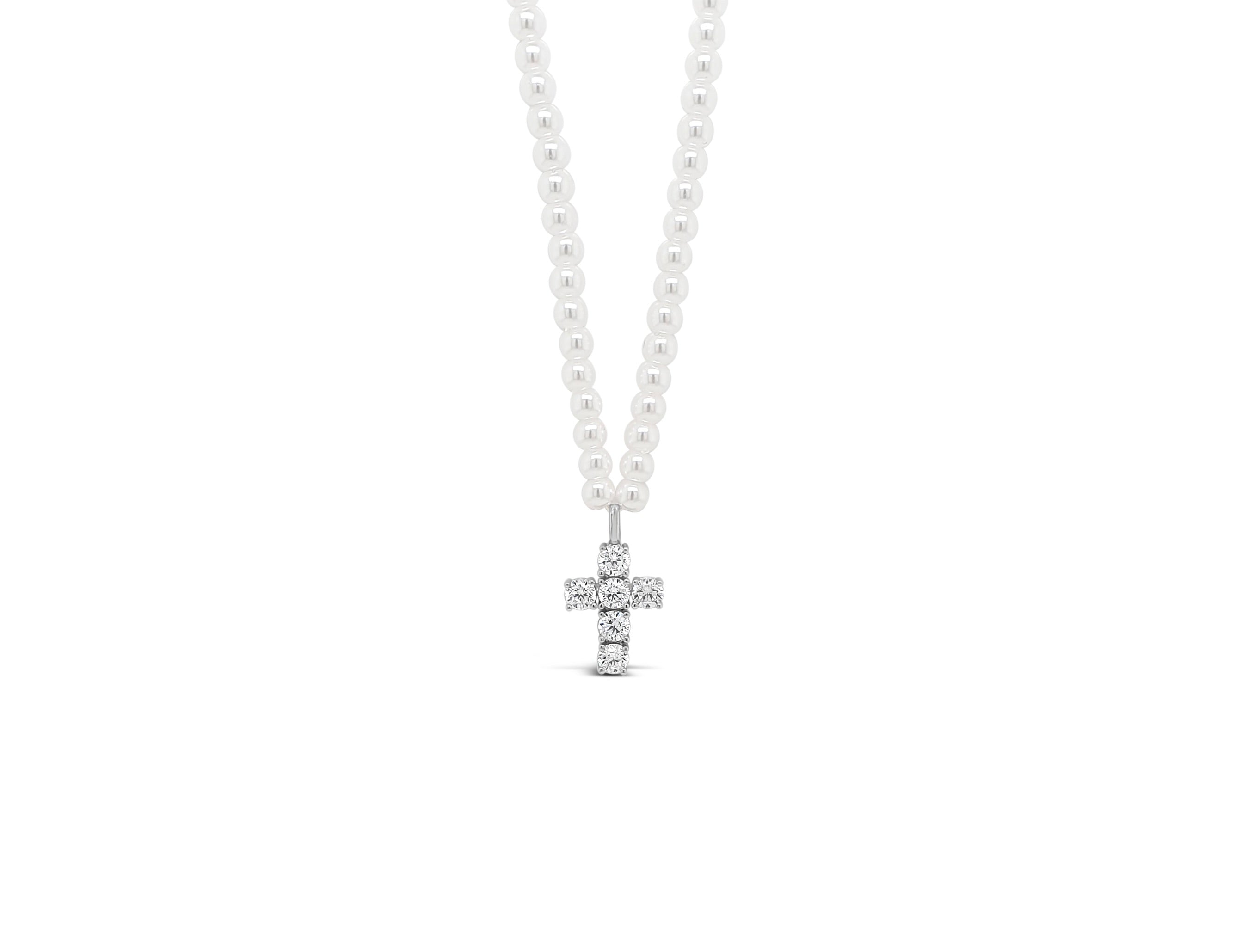 Children's Pearl and Silver cross necklace on a white background