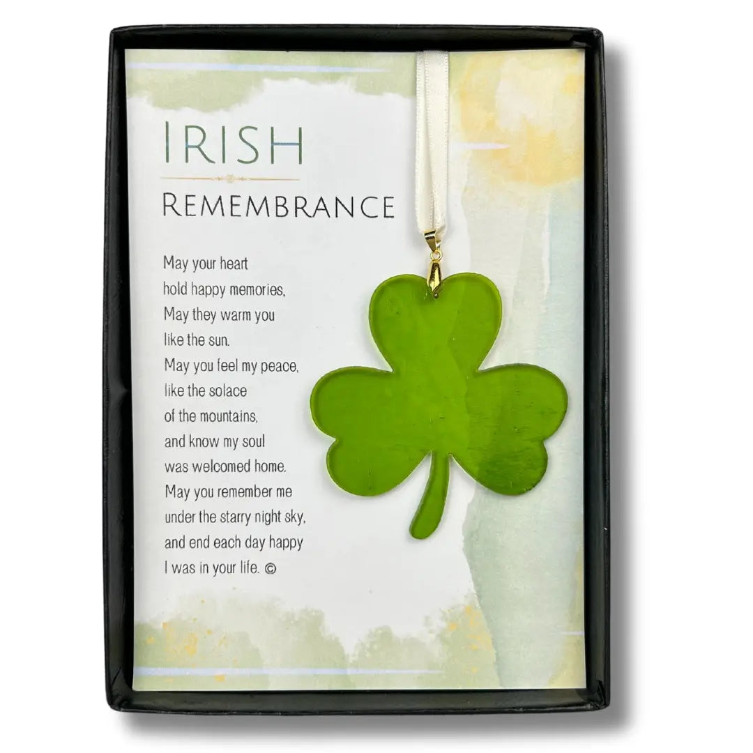 Green shamrock pendant on a card with text in a decorative frame