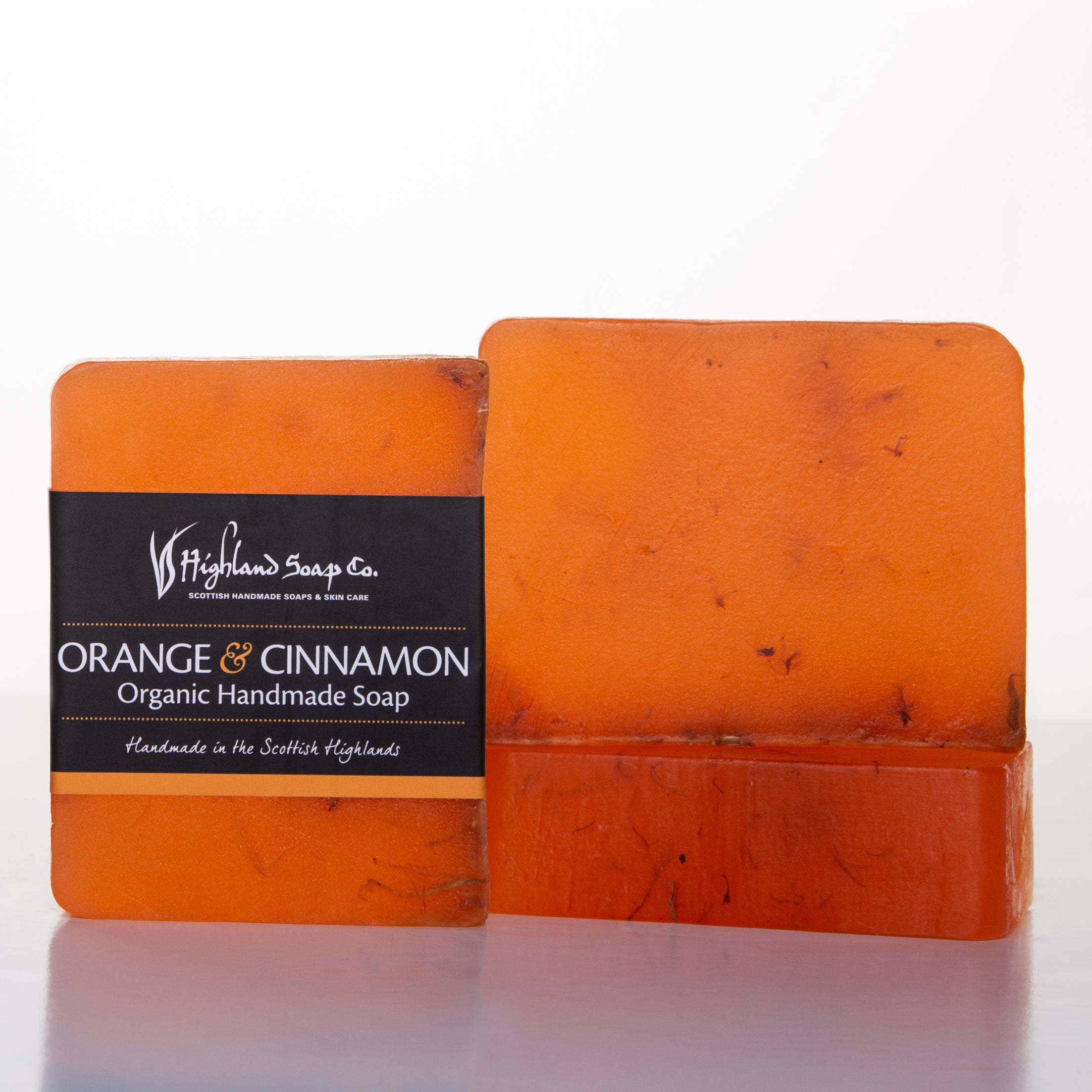 Orange handmade soap with 'Highland Soap Co.' label on a white background