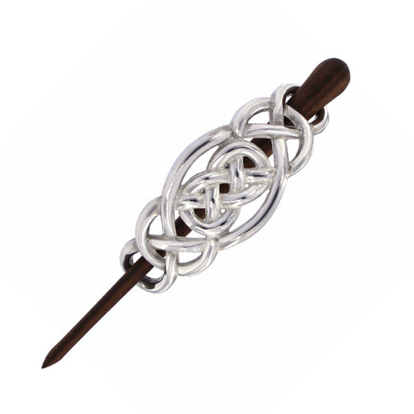 Silver hairpin with intricate Celtic knot design on a white background
