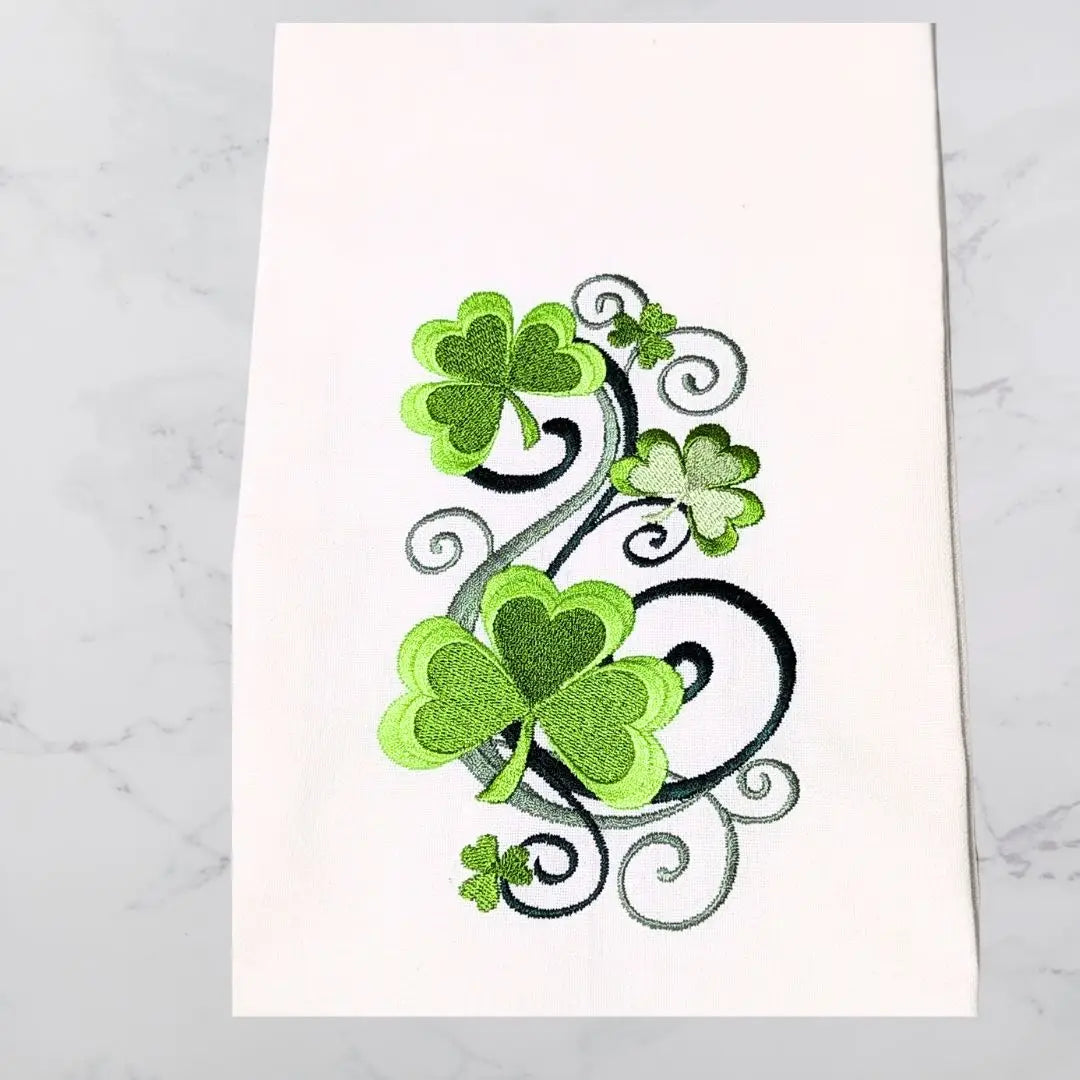 Decorative towel with green shamrock design on a white background