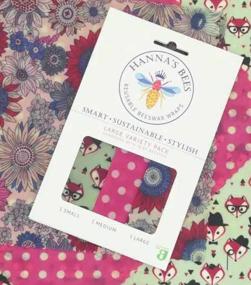 Hanna's Bees reusable beeswax wraps packaging on a patterned fabric background