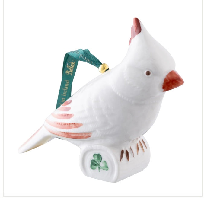 White bird ornament with a red beak and green ribbon on a white background
