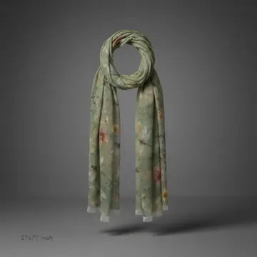 A lightweight scarf in sage green with a delicate floral pattern, draped in a loop to show its length and pattern, set against a dark gray studio background.