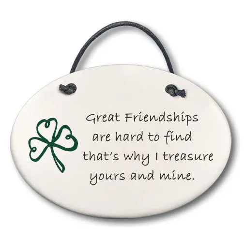 Round ceramic plaque with a shamrock and friendship quote on a white background