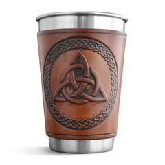 Brown leather-wrapped cup with Celtic knot design on a white background