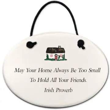 Decorative plaque with an Irish proverb and a small house illustration on a white background