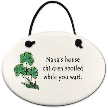 Round ceramic ornament with shamrock design and text on a white background