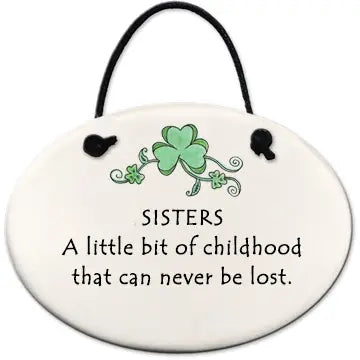 Decorative plaque with shamrock design and text about sisters on a white background