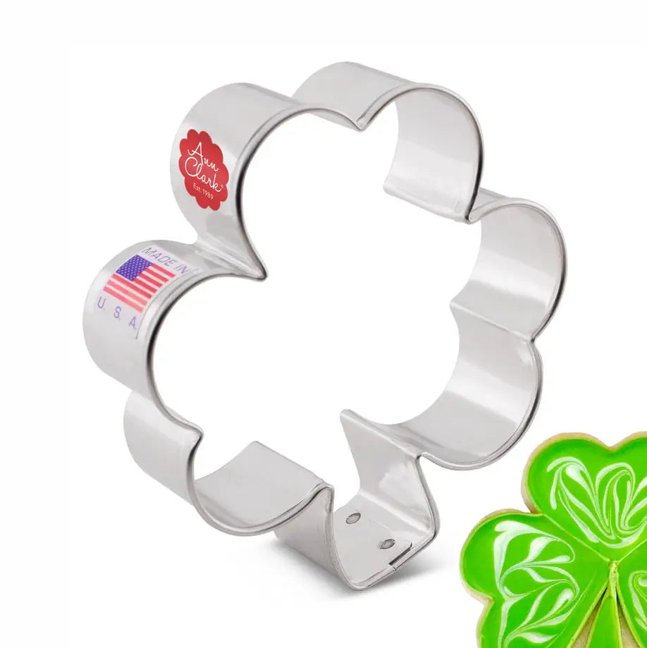 Metallic shamrock-shaped cookie cutter with 'Made in USA' label on a white background.