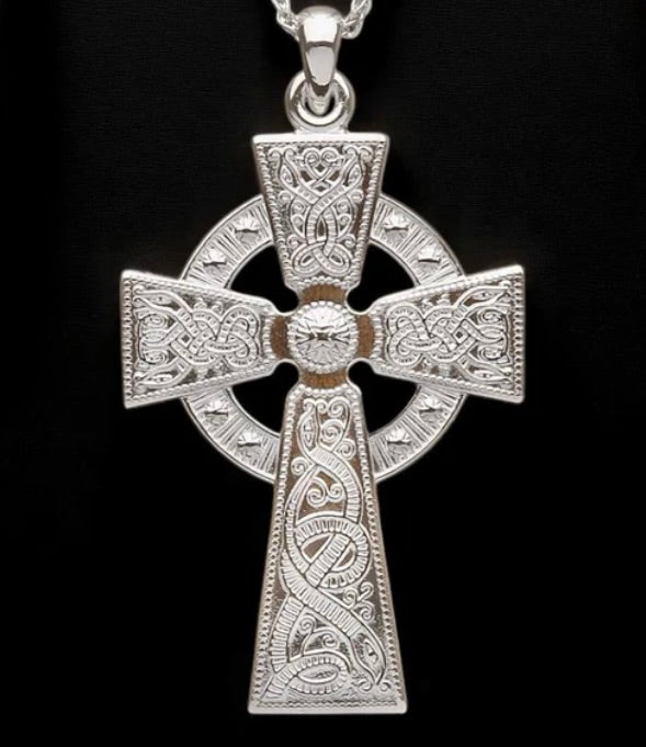 Silver Celtic cross pendant on a black background
