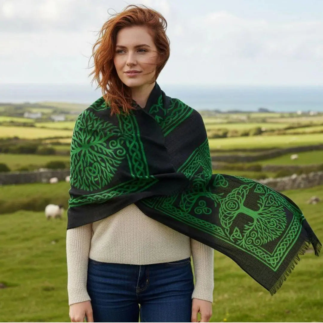 Woman wearing a green and black patterned scarf in a scenic outdoor setting