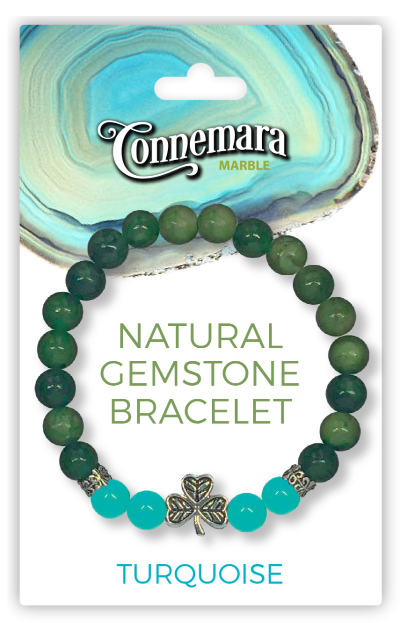 Green and turquoise gemstone bracelet with a shamrock charm on Connemara Marble packaging.