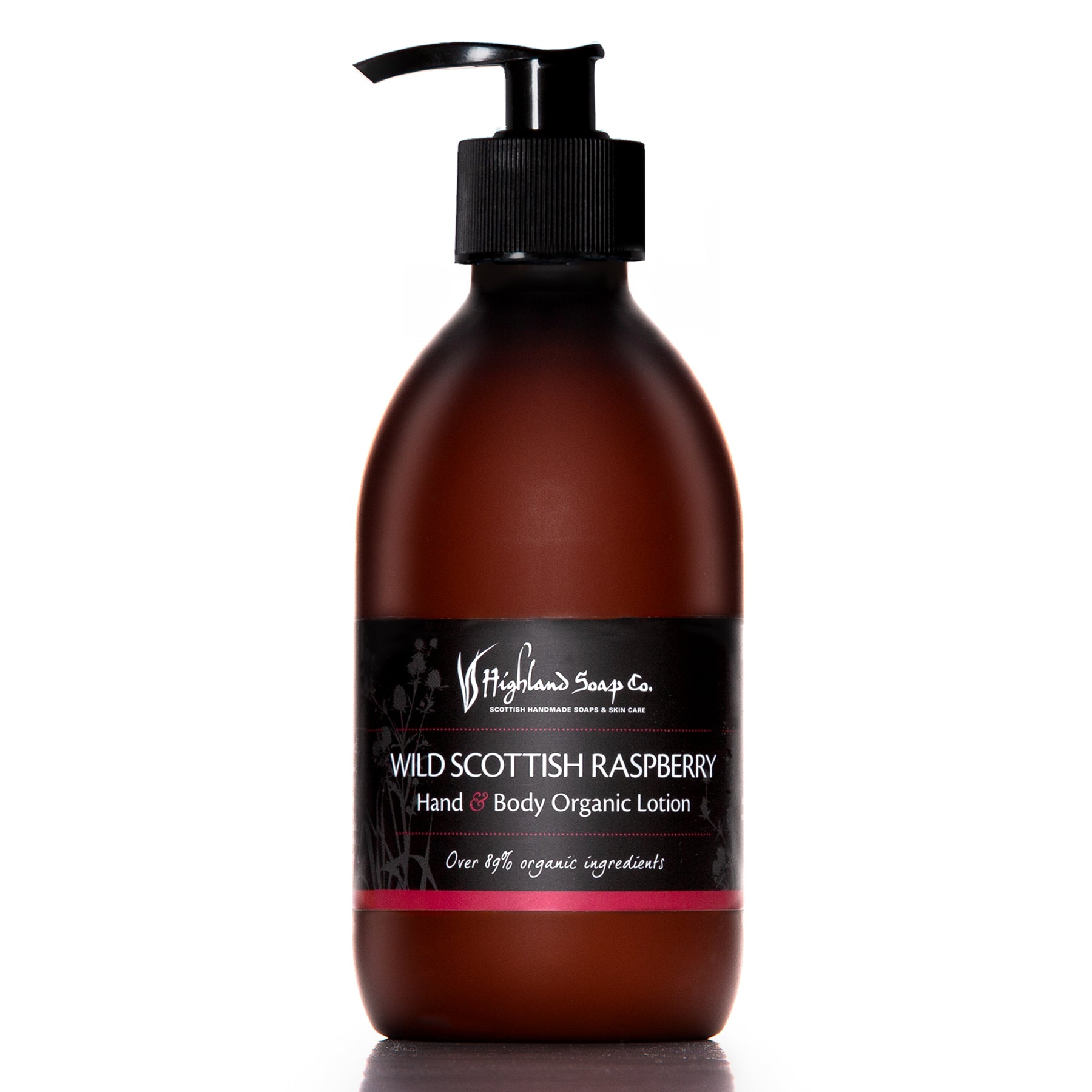 Brown bottle of Wild Scottish Raspberry hand and body organic lotion with a pump on a white background