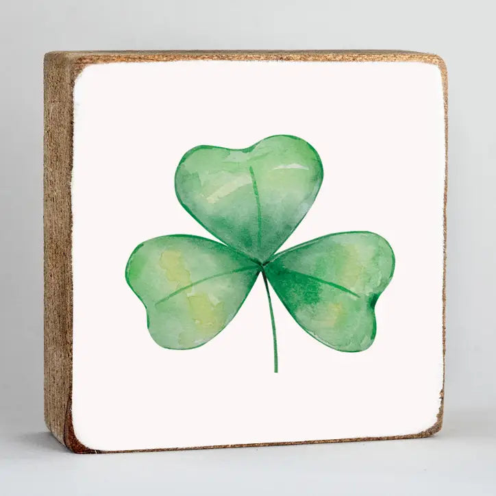 Green shamrock on a white background with wooden frame