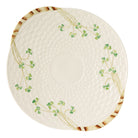 Round ceramic plate with decorative green patterns on a white background