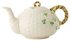 Decorative teapot with shamrock design on a white background