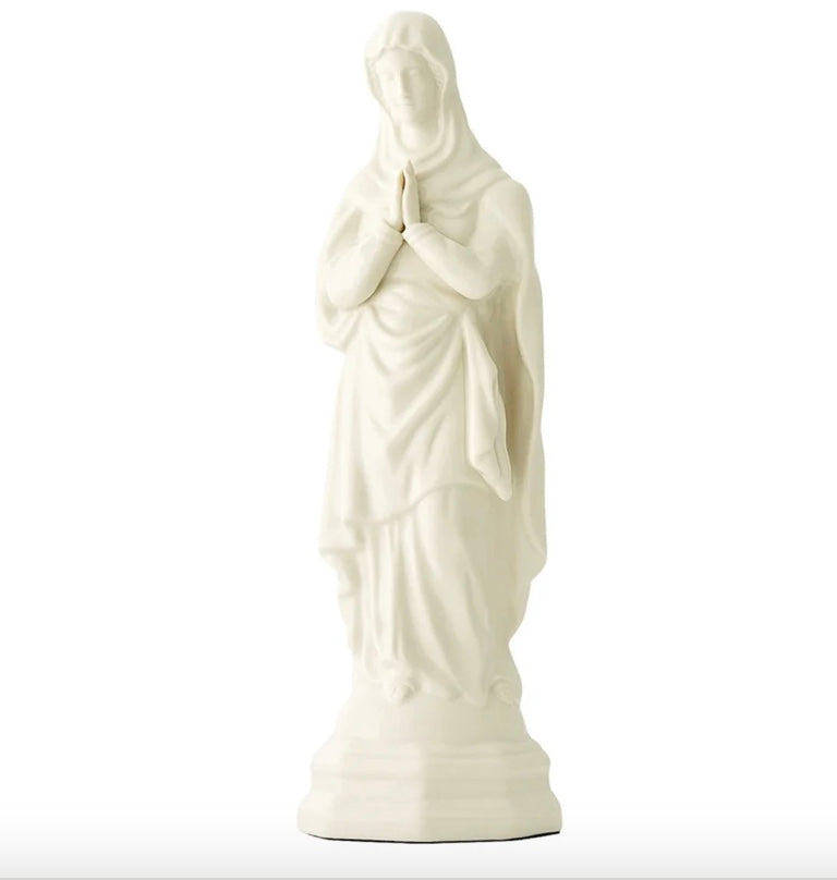 White statue of a draped figure on a white background