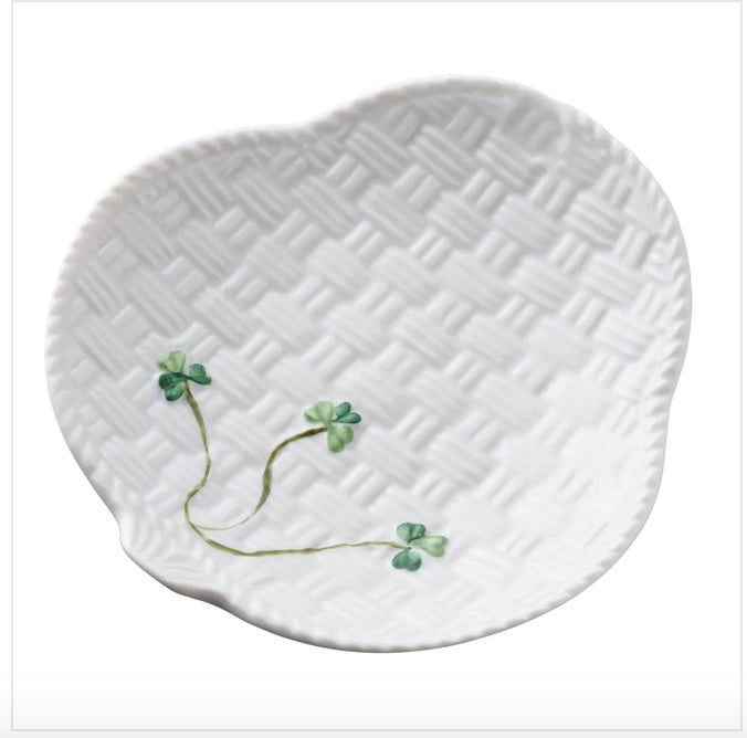 White ceramic plate with wicker pattern and clover design on a white background