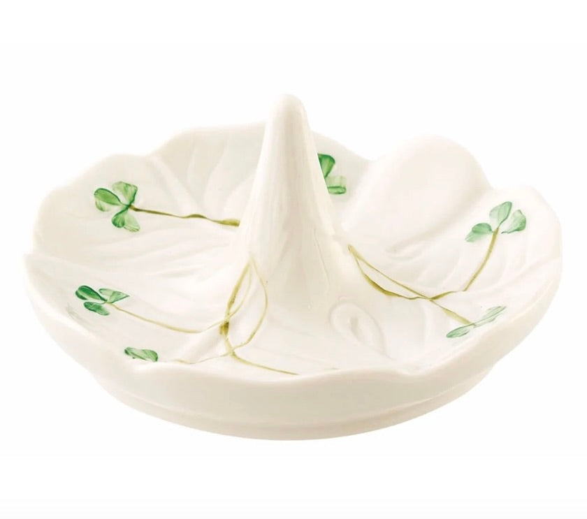 White ceramic ring holder with green leaf patterns on a white background