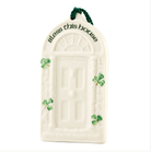 Decorative door-shaped ornament with 'Bless this house' text and shamrock designs on a white background.