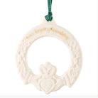 White ceramic claddagh ornament with gold text on a white background