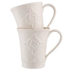 Two white ceramic mugs with Celtic knot design on a white background