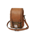 Brown leather and tweed crossbody bag on a white background