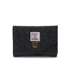 Black textured wallet with a brand label on a white background