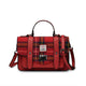 Red plaid handbag with leather straps on a white background