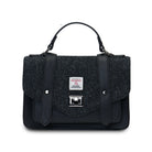Black textured handbag with a strap on a white background