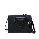 Black textured handbag with a braided detail on a white background