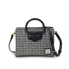 Houndstooth pattern handbag with black leather accents on a white background