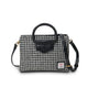 Houndstooth pattern handbag with black leather accents on a white background