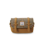 Brown and beige checkered bag with leather straps on a white background