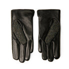 Pair of black leather gloves with textured palm on a white background