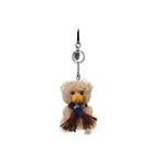 Plush Highland cow keychain with a scarf on a white background