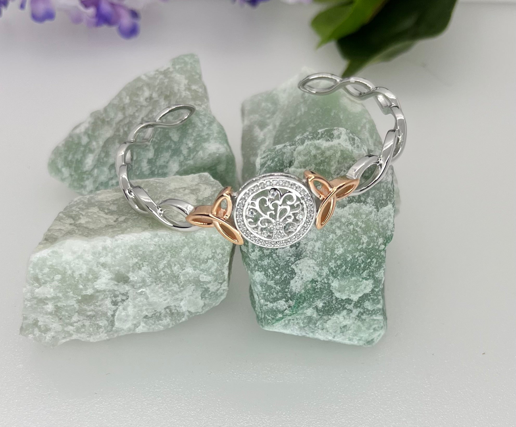 Silver and rose gold bracelet with intricate design on green stone